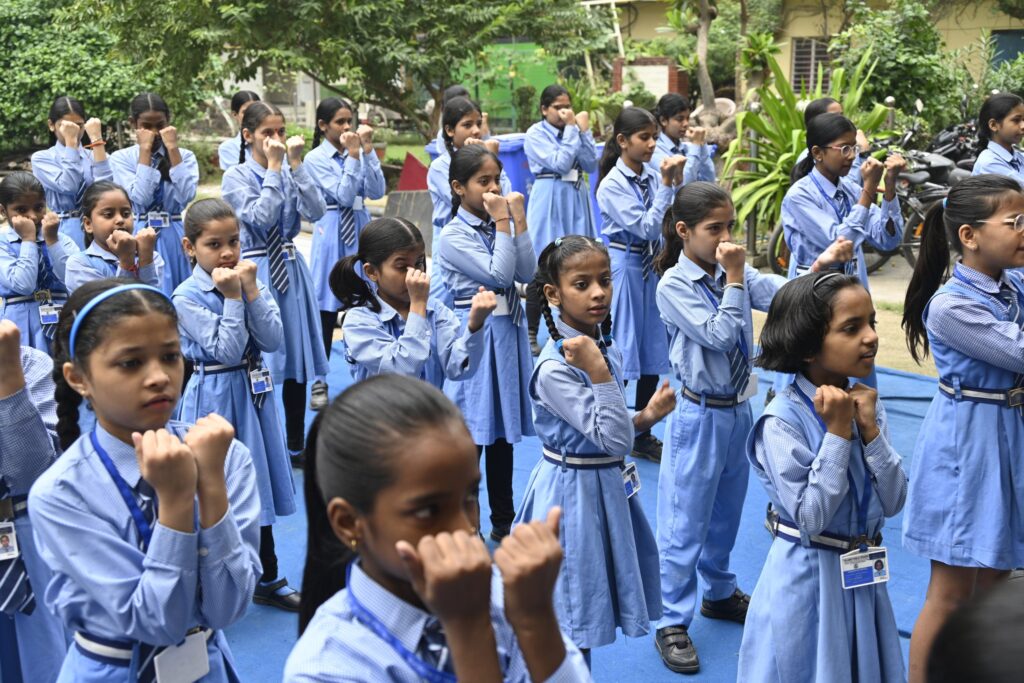 Girl Students Practise Self-Defense Guard Position Girl students holding a self-defense guard position during the training programme