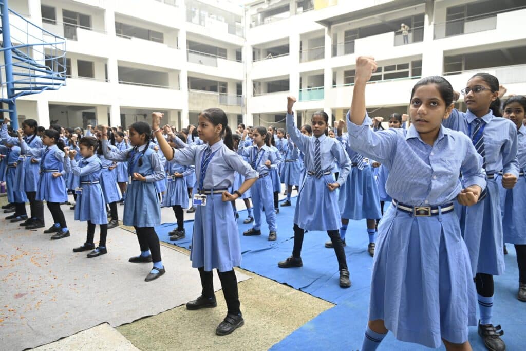 Student Practises Self-Defense Block Technique Student practising a raised-arm self-defense block technique with classmates